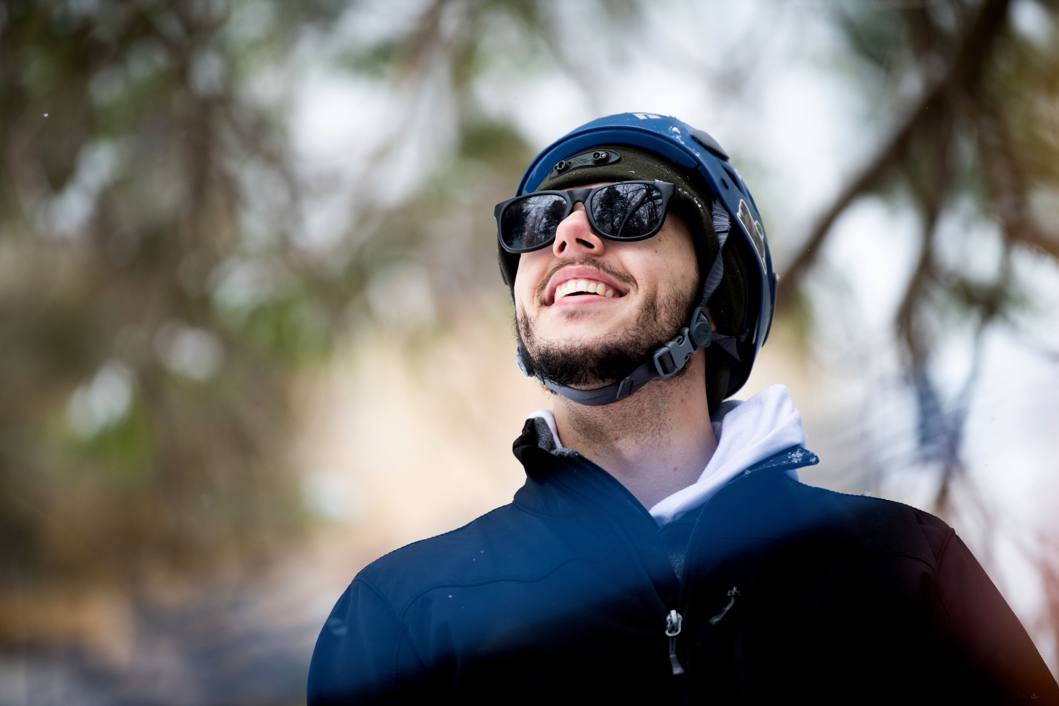 Andy Hardgrave smiles while watching other climbers during Ice Fest on February 15.