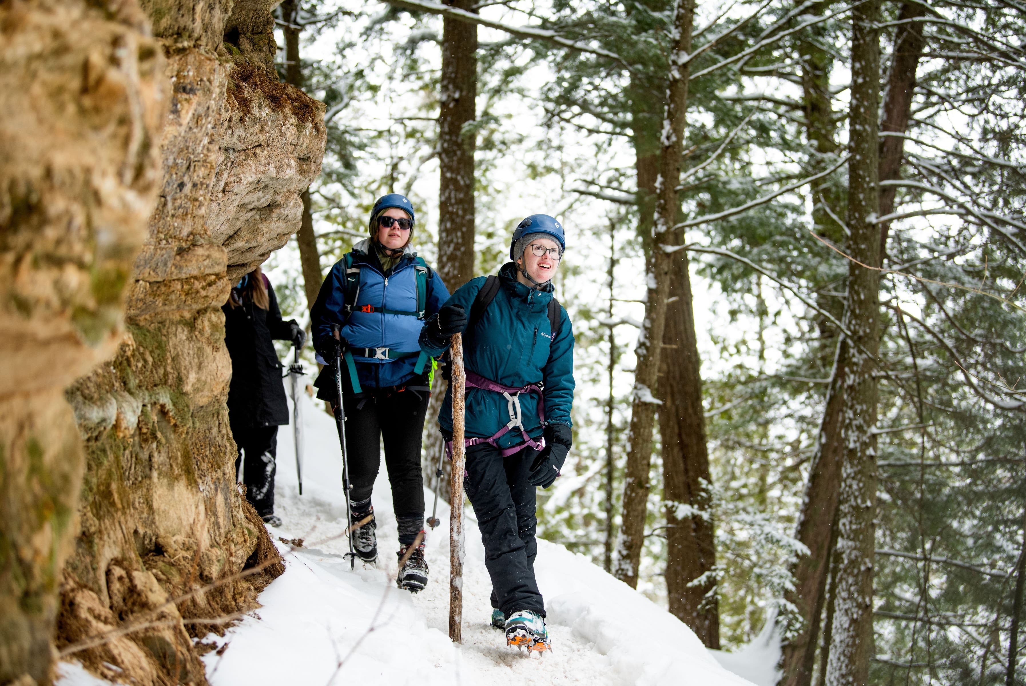 Isabelle Moore, followed by Emalee Anderson, hike through Pictured Rocks National Lakeshore from one ice climbing location to the next.