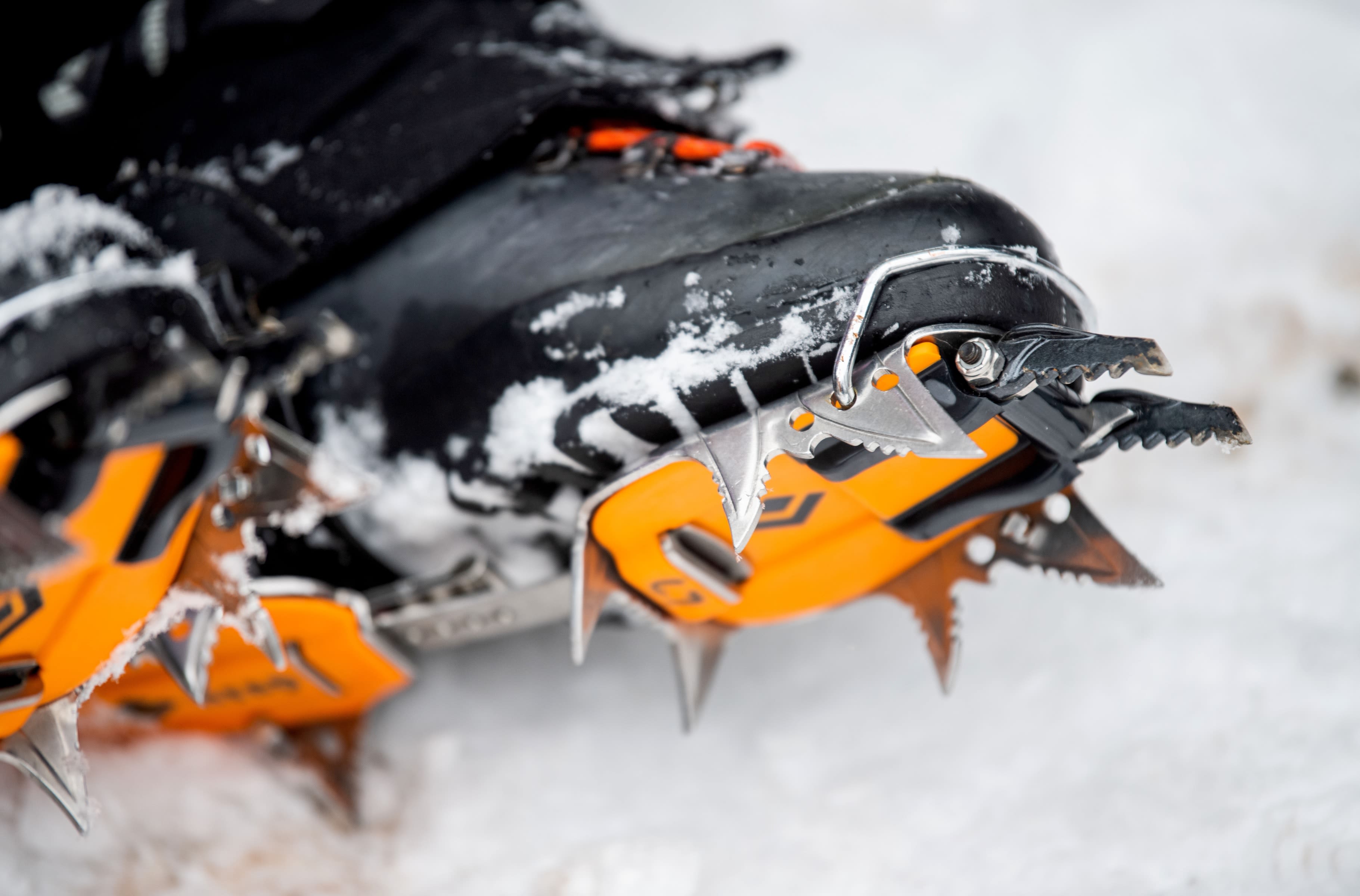 A close-up of crampons, metal spikes that attach to boots for ice climbing.