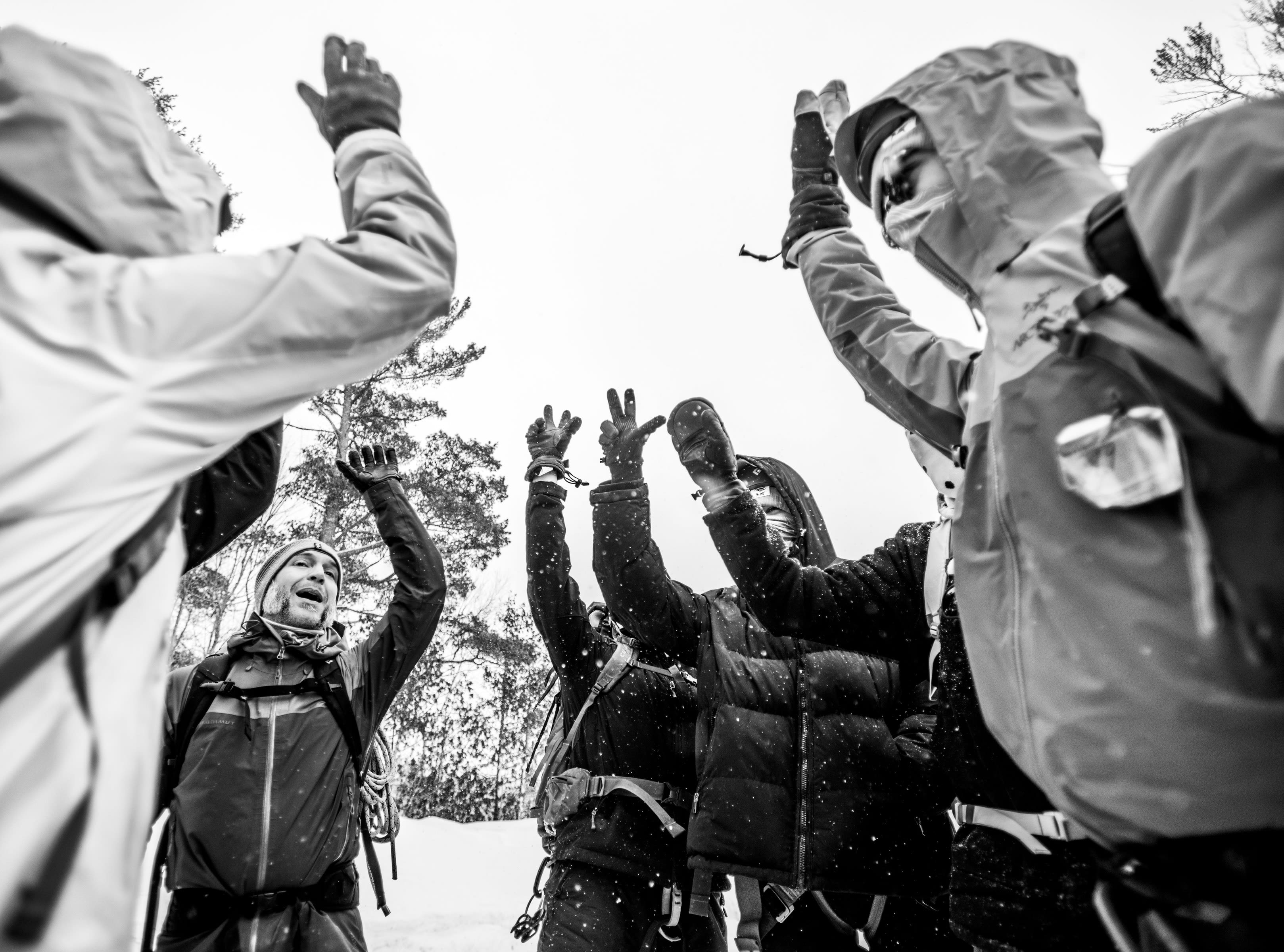 Joe Bitely and students put their hands in together in a show of solidarity and teamwork.