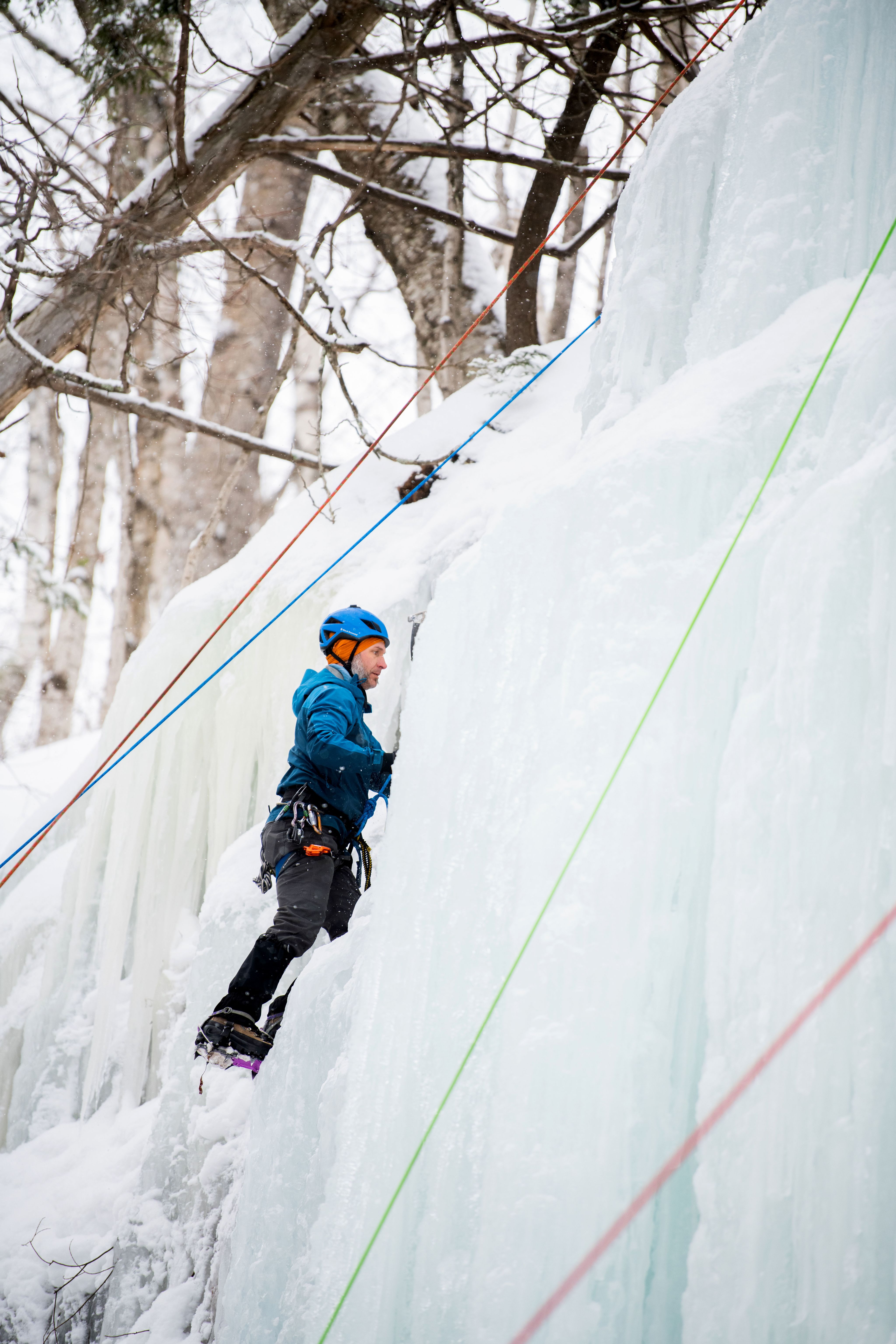 Joe Bitely, assistant director of Recreation and Wellness, climbs the Curtains during Ice Fest. 