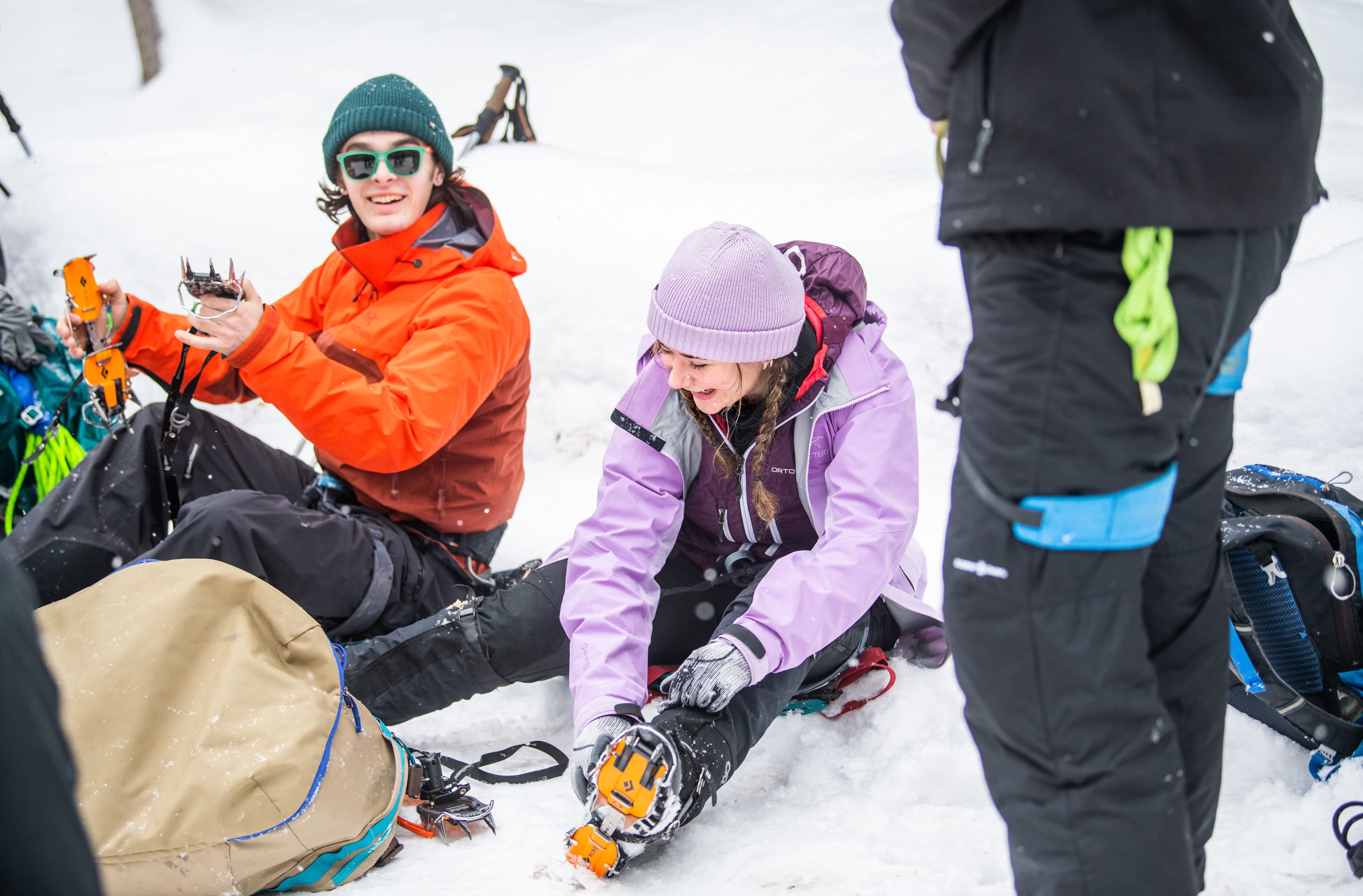 Walker Fairbanks, left, and Audrey Bulow prepare for their climbs by attaching crampons to their boots.