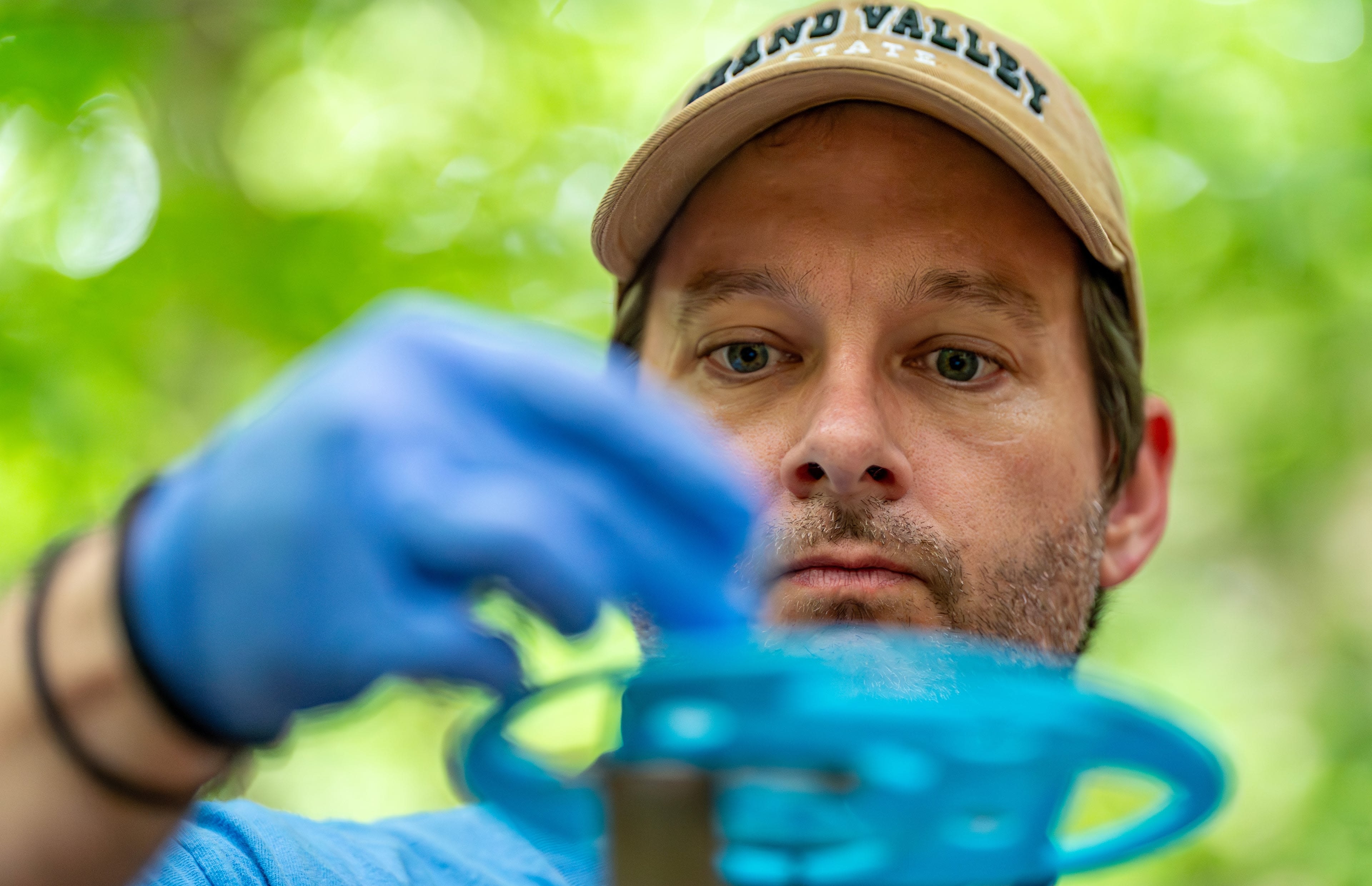 A close-up view of a person wearing latex gloves focusing on equipment.