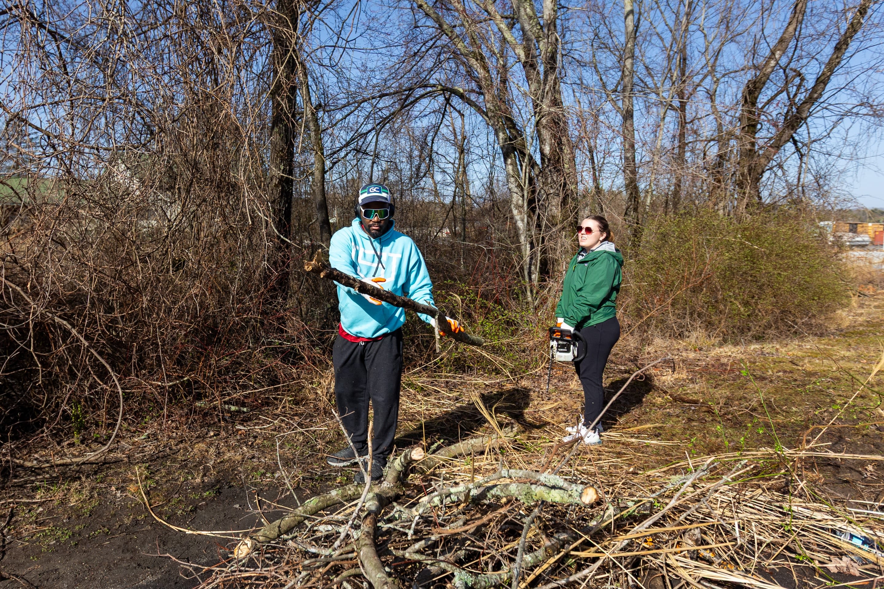 SLAM advisor Quincy Williams and Grace Clark, a sophmore studying Advertising and Public Relations, clear large branches.