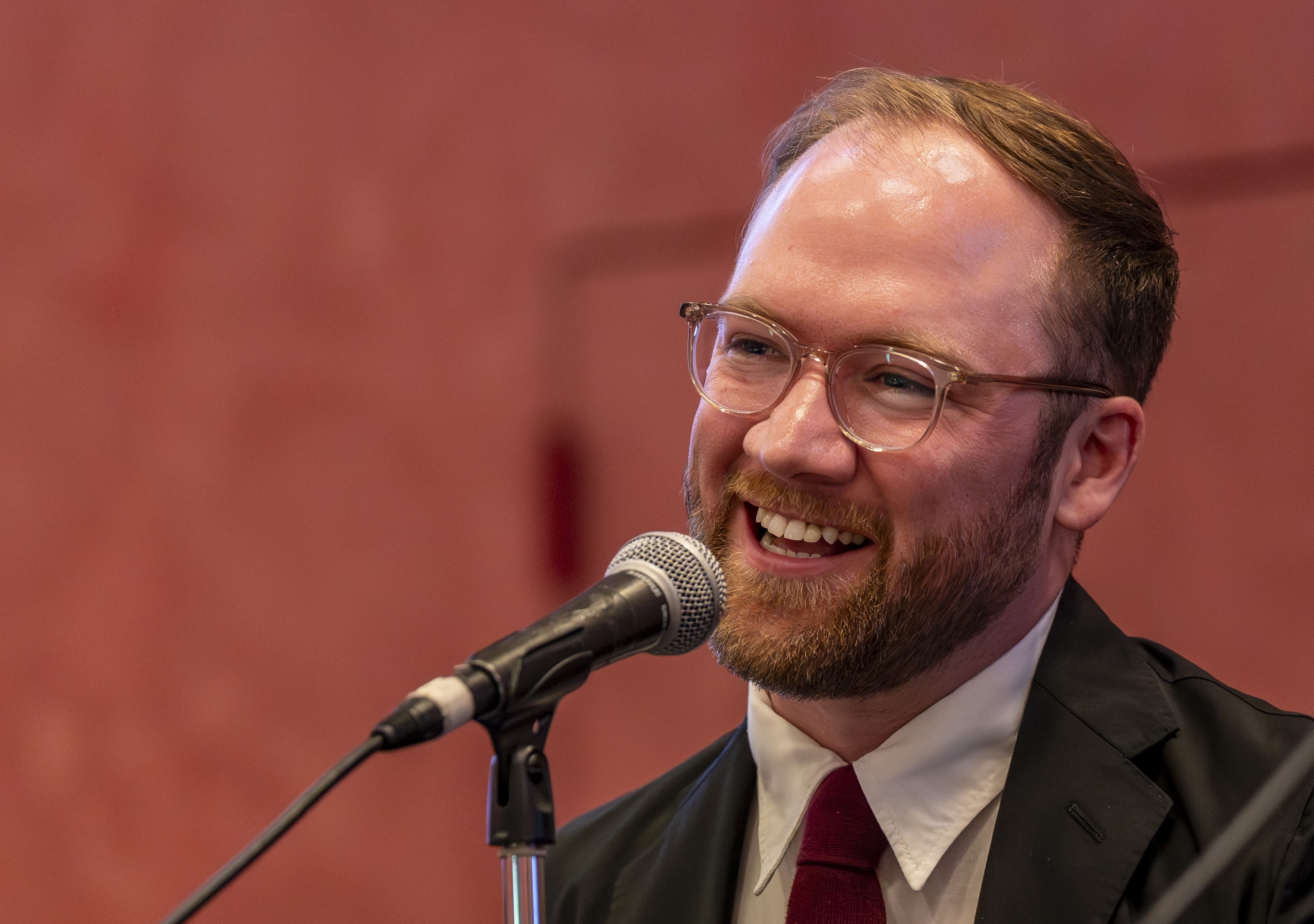 Landon Hughes, '14, speaks during a conference on student research in Grand Rapids.
