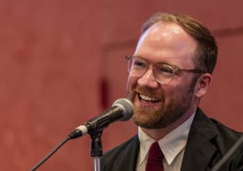 Landon Hughes, '14, speaks during a conference on student research in Grand Rapids.