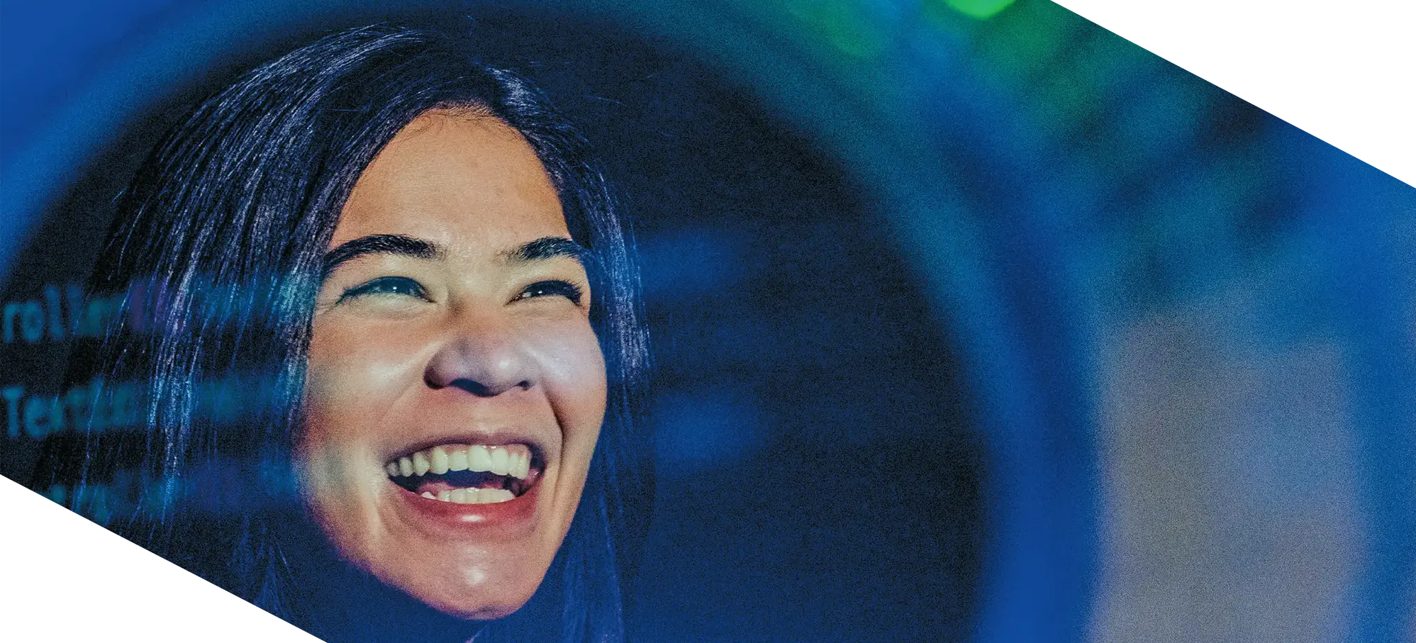 A student’s joyful expression reflects through illuminated code — a portrait of creativity and the future of artificial intelligence.