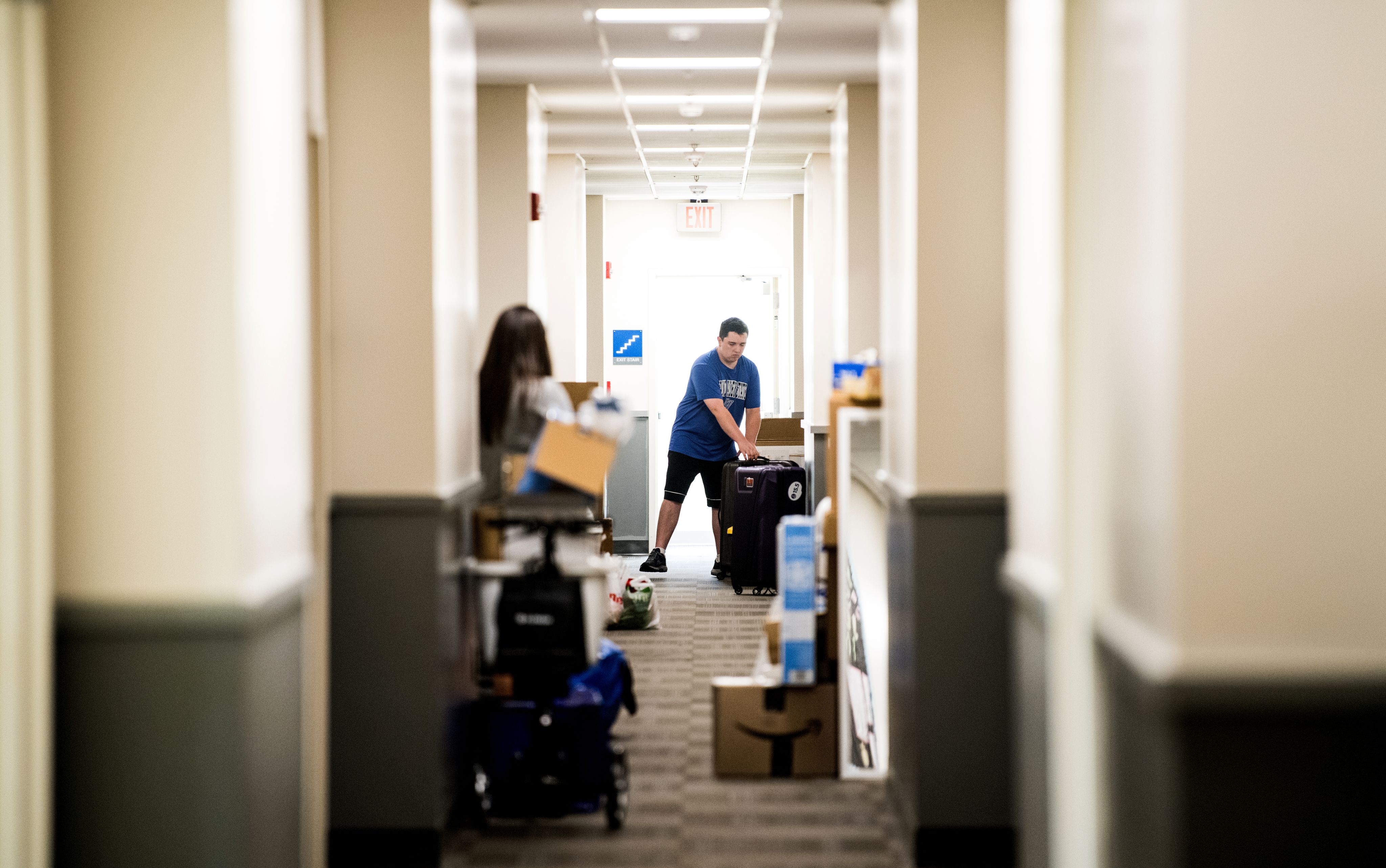 students moving boxes in a GVSU living center