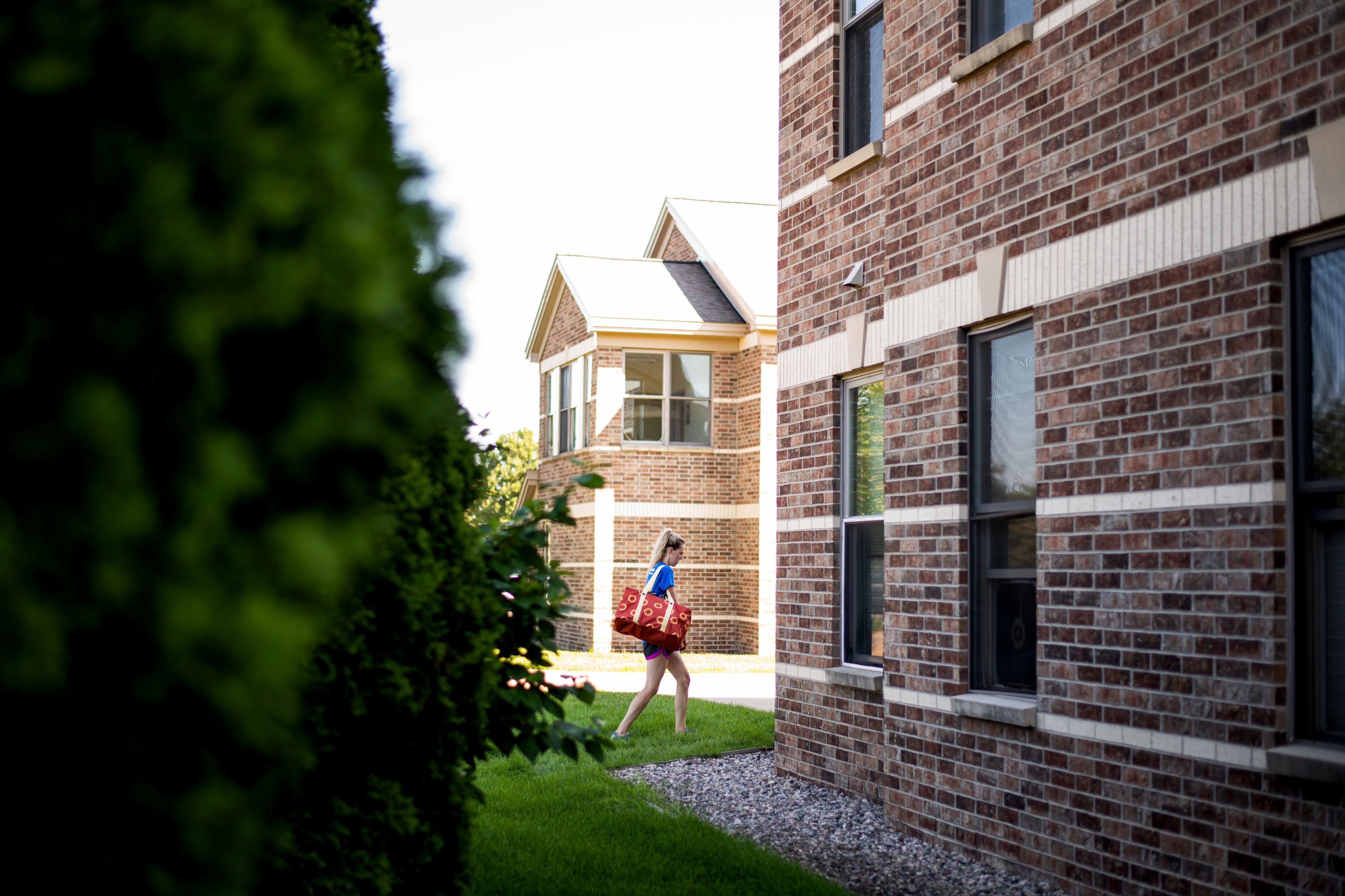 student walking into a living center