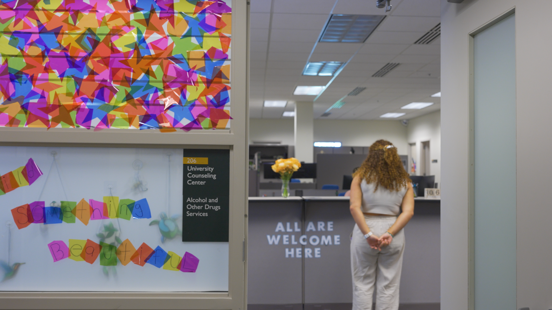 Student standing at reception desk in the University Counseling Center
