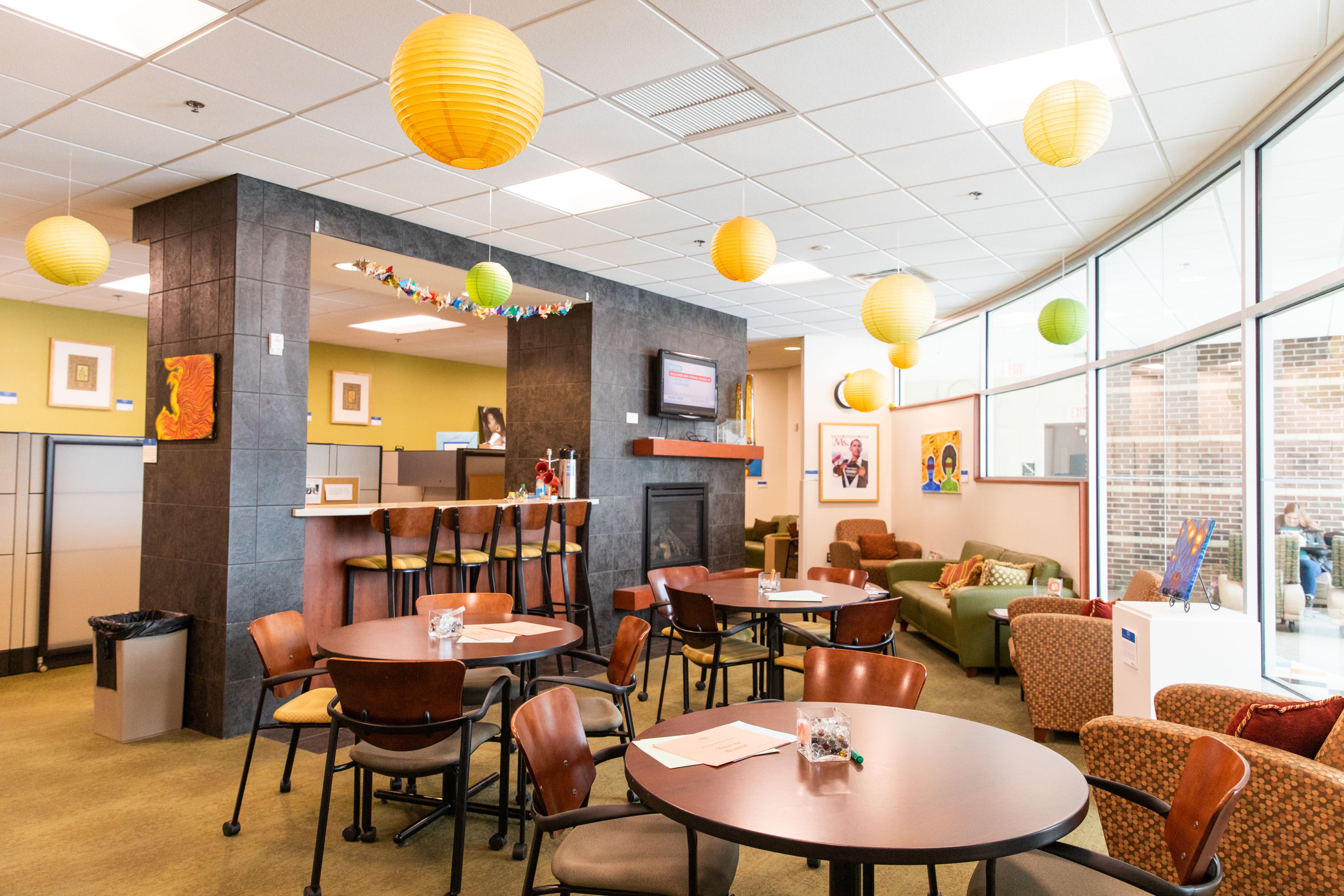 Center for Women and Gender Equity lobby space with tables and coffee station
